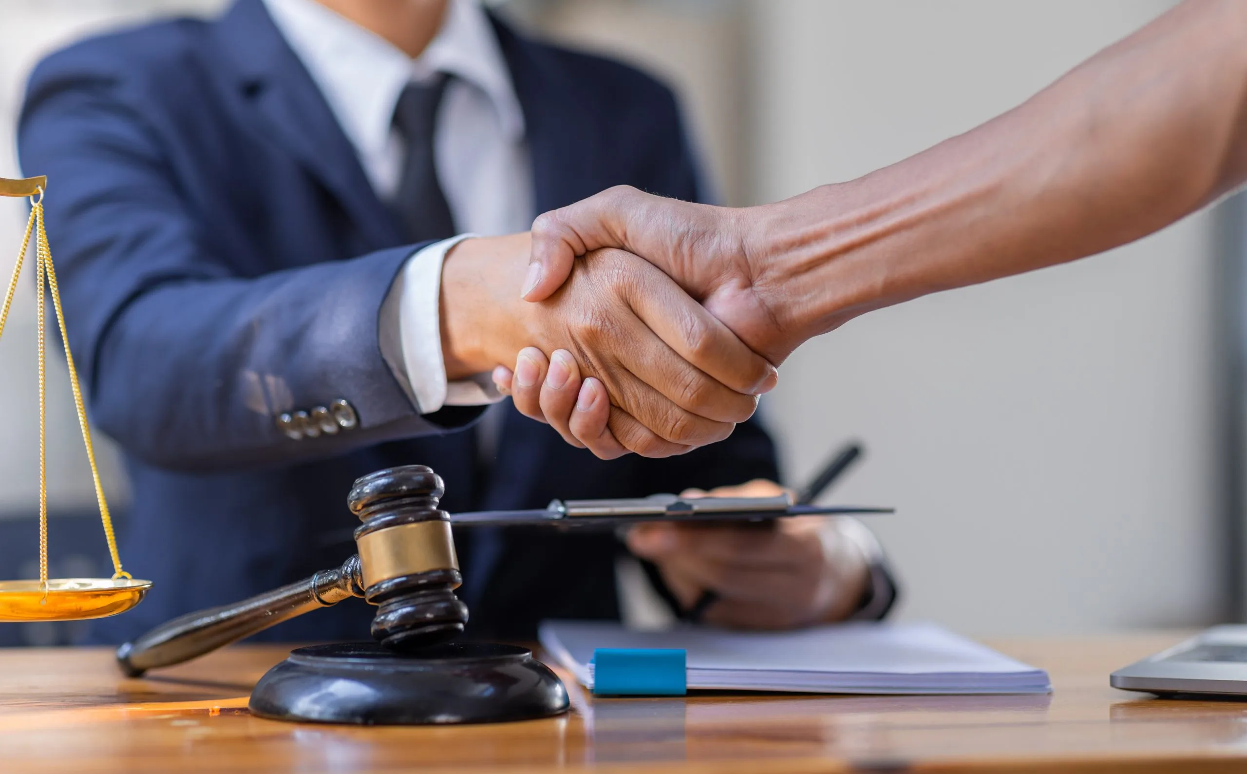 business-handshake-with-legal-scale-and-gavel-2026-01-08-02-41-03-utc